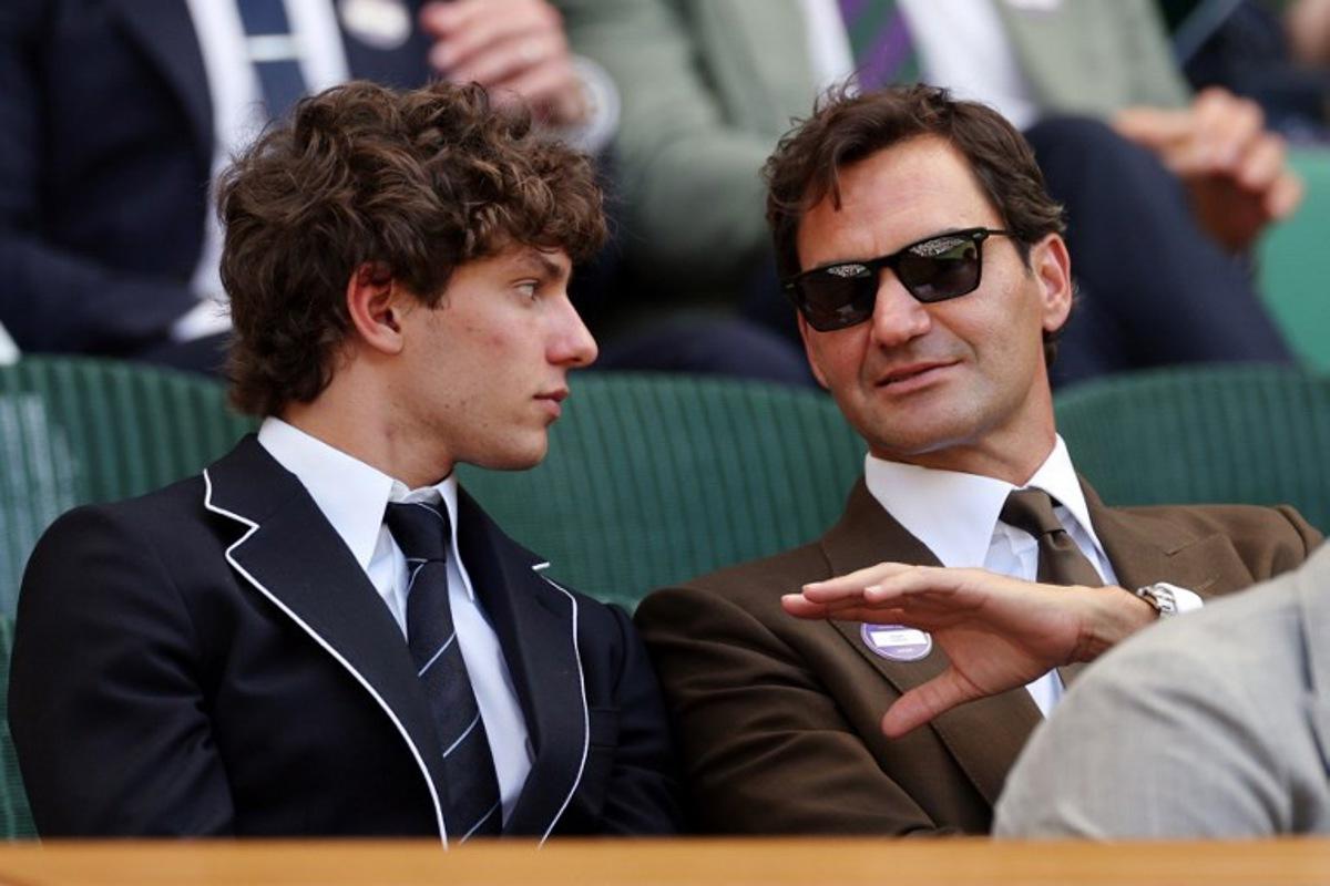 Italian driver Kimi Antonelli (L) listents to Swiss former tennis player Roger Federer at the Centre Court's Royal Box on the eighth day of the 2026 Wimbledon Championships at The All England Lawn Tennis and Croquet Club in Wimbledon, southwest London, on July 6, 2026. Adrian Dennis / AFP