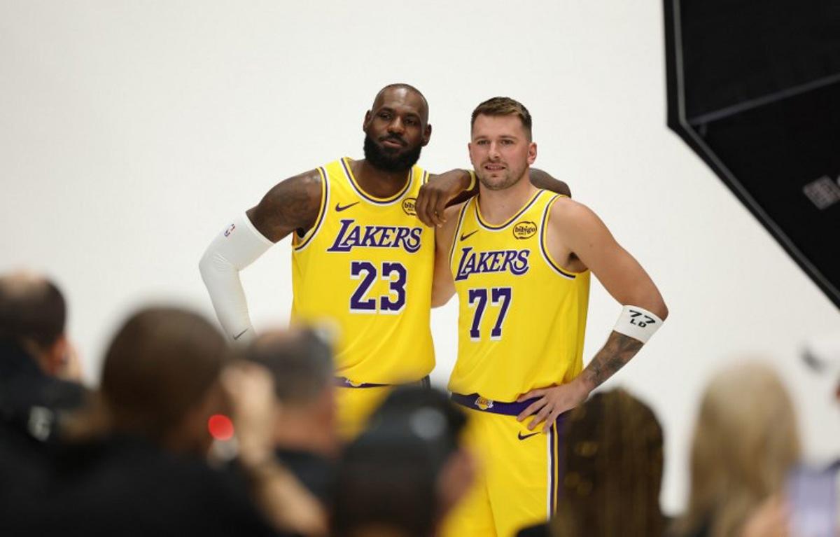 US basketball player LeBron James (L) and Slovenian basketball player Luka Doncic (R) pose for photos during the Los Angeles Lakers media day at UCLA Health Training Center El Segundo, California on September 29, 2025. Patrick T. Fallon / AFP