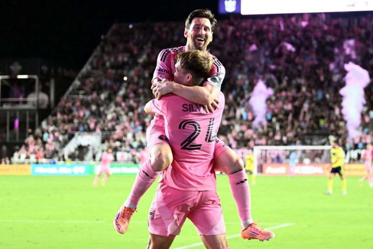 Inter Miami's Argentine forward #10 Lionel Messi celebrates scoring his second goal with Argentine midfielder #24 Mateo Silvetti during the Major League Soccer (MLS) playoff football match between Inter Miami and Nashville SC at Chase Stadium in Fort Lauderdale, Florida on November 8, 2025. CHANDAN KHANNA / AFP