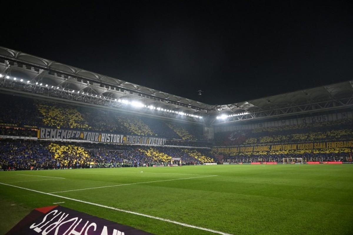 Fenerbahce's fans cheers for their team before the Turkish Super lig football match between Fenerbahce and Galatasaray at the Fenerbahce Sukru Saracoglu stadium in Istanbul, on December 1, 2025. Ozan KOSE / AFP