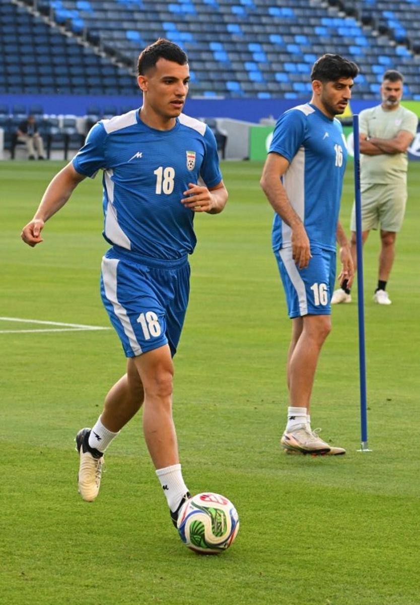 Iran's forward #18 Amirhossein Hosseinzadeh and Iran's midfielder #16 Mehdi Torabi take part in a training session at Carson Sports Park in Carson, California on June 14, 2026, on the eve of the 2026 World Cup football match between Iran and New Zealand. Patrick T. Fallon / AFP
