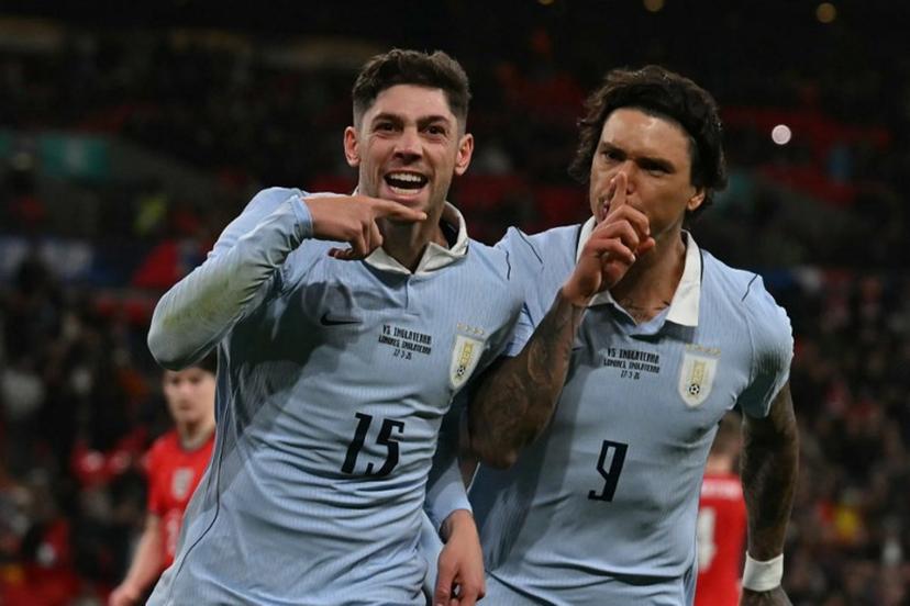 Uruguay's midfielder Federico Valverde (L) celebrates with Uruguay's forward Darwin Nunez (R) after scoring their first goal from the penalty spot during the friendly International football match between England and Uruguay at Wembley Stadium, west London, on March 27, 2026. Glyn KIRK / AFP