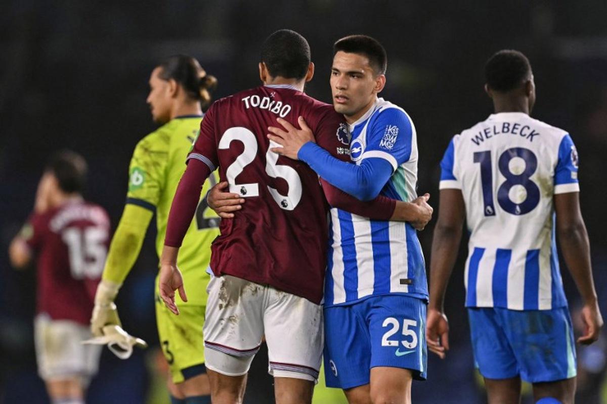 Brighton's Paraguayan midfielder #25 Diego Gomez (R) and West Ham United's French defender #25 Jean-Clair Todibo (L) embrace at the end of the English Premier League football match between Brighton and Hove Albion and West Ham United at the American Express Community Stadium in Brighton, southern England on December 7, 2025. Glyn KIRK / AFP