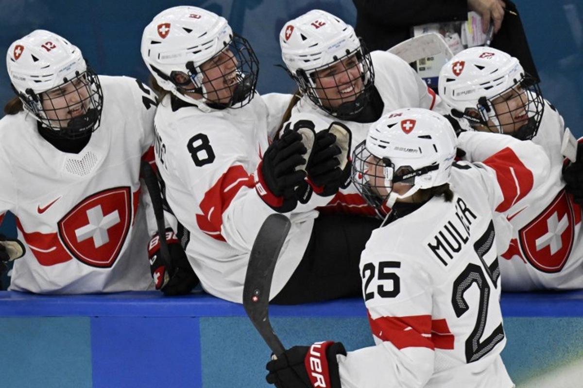 Switzerland's forward #25 Alina Muller celebrates teammates following their first goal socred by Switzerland's forward #21 Rahel Enzler during the women's play-off semi-final ice hockey match between Canada and Switzerland at the Milano Santagiulia Ice Hockey Arena during the Milano Cortina 2026 Winter Olympic Games in Milan, on February 16, 2026. Alexander NEMENOV / AFP