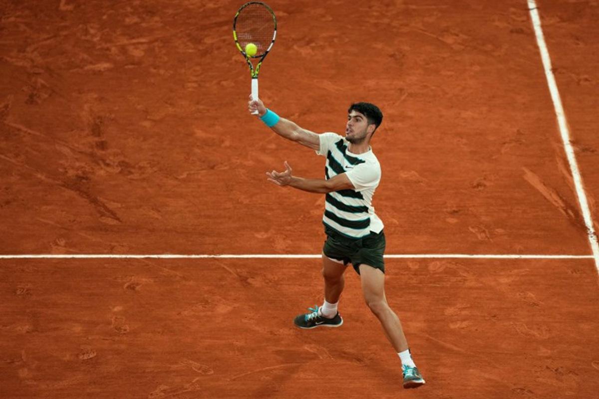 Spain's Carlos Alcaraz plays a forehand return to Italy's Lorenzo Musetti during their men's singles semi-final match on day 13 of the French Open tennis tournament on Court Philippe-Chatrier at the Roland-Garros Complex in Paris on June 6, 2025. Dimitar DILKOFF / AFP