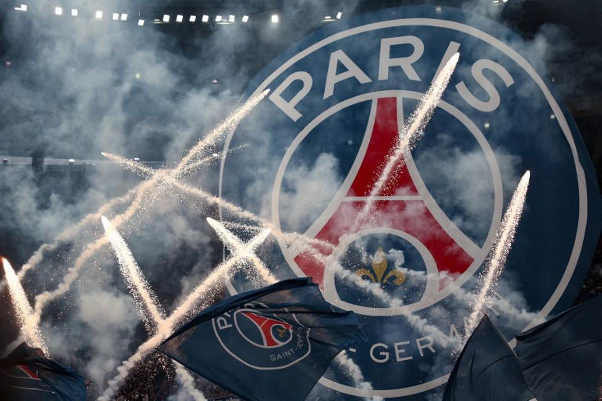 Flags and banners with the PSG logo are waved as fireworks are set off during a show prior to the French Cup final football match between Paris Saint-Germain (PSG) and Stade de Reims at the Stade de France in Saint-Denis, north of Paris, on May 24, 2025. FRANCK FIFE / AFP